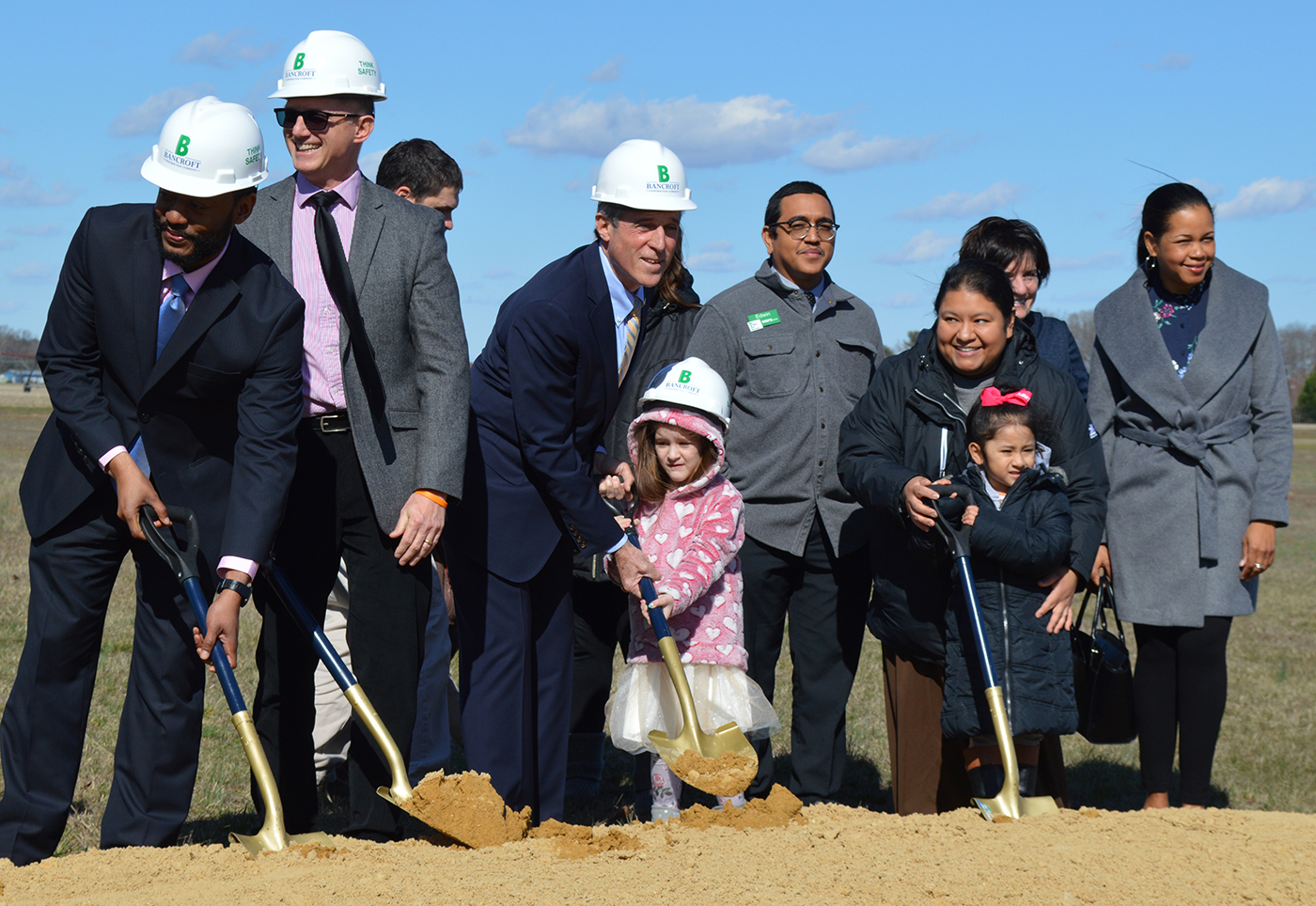 Governor John Carney, Board members and families shovel dirt during ground breaking ceremony.